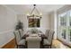 Formal dining room with a chandelier, a table set for six, and a large window offering natural light at 4284 Windy Gap Nw Ct, Kennesaw, GA 30144
