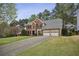 Beautiful brick home with a two-car garage and long driveway, surrounded by lush trees and greenery at 4284 Windy Gap Nw Ct, Kennesaw, GA 30144