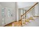 Bright foyer features hardwood floors, a staircase, and a decorative glass front door at 4284 Windy Gap Nw Ct, Kennesaw, GA 30144