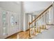 Bright foyer with hardwood floors, staircase, and leaded glass front door features high ceilings at 4284 Windy Gap Nw Ct, Kennesaw, GA 30144