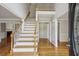 Grand foyer with hardwood floors, a staircase with wooden railings, and views into the living spaces at 4284 Windy Gap Nw Ct, Kennesaw, GA 30144
