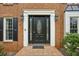 Welcoming front entrance with a brick walkway, elegant door with sidelights, and manicured landscaping at 4284 Windy Gap Nw Ct, Kennesaw, GA 30144