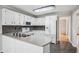 White kitchen with granite counters, white appliances, and decorative backsplash at 4284 Windy Gap Nw Ct, Kennesaw, GA 30144