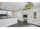 Open kitchen featuring white cabinets, island with sink, and eat-in area at 4284 Windy Gap Nw Ct, Kennesaw, GA 30144