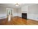 Living room with fireplace, hardwood floors and wainscotting, plenty of natural light at 4284 Windy Gap Nw Ct, Kennesaw, GA 30144