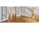 Elegant hardwood floors in living room with staircase, French doors, and wainscotting at 4284 Windy Gap Nw Ct, Kennesaw, GA 30144