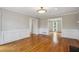 Bright open living room with hardwood floors, wainscotting, and multiple entryways at 4284 Windy Gap Nw Ct, Kennesaw, GA 30144