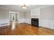 Spacious living room with hardwood floors, fireplace, wainscotting and ample natural light at 4284 Windy Gap Nw Ct, Kennesaw, GA 30144