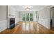 Cozy living room featuring hardwood floors, fireplace, wainscotting and ample natural light at 4284 Windy Gap Nw Ct, Kennesaw, GA 30144