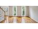 Spacious living room with hardwood floors, large windows, and natural light at 4284 Windy Gap Nw Ct, Kennesaw, GA 30144