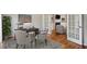 Bright office space with hardwood floors, a desk, and a view into a cozy living area at 4284 Windy Gap Nw Ct, Kennesaw, GA 30144