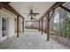 Covered stone patio featuring ceiling fans and provides a comfortable outdoor living space with backyard access at 4284 Windy Gap Nw Ct, Kennesaw, GA 30144