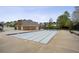 Large empty community pool area with expansive concrete patio and brick pool house, perfect for summer gatherings at 4284 Windy Gap Nw Ct, Kennesaw, GA 30144