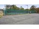 Full tennis court for residents with parking and lighting within a beautifully maintained and fenced common area at 4284 Windy Gap Nw Ct, Kennesaw, GA 30144