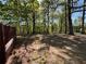 View of wooded backyard with mature trees and partial fence at 5130 English Dr, Cumming, GA 30041