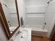 Bathroom with white shiplap walls and a shower-tub combo at 5130 English Dr, Cumming, GA 30041
