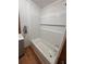 Bright bathroom features a white bathtub with a built-in shelf and modern fixtures at 5130 English Dr, Cumming, GA 30041