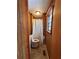 Narrow bathroom features a wood paneled wall, a toilet, and a shower curtain at 5130 English Dr, Cumming, GA 30041