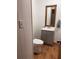 Small bathroom features a vanity with a sink, a toilet, and a mirror at 5130 English Dr, Cumming, GA 30041