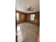 Spacious bedroom with wood paneled walls, a ceiling fan, and two windows at 5130 English Dr, Cumming, GA 30041