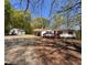 Charming single-story home with white siding, a cozy front porch, and a detached garage at 5130 English Dr, Cumming, GA 30041