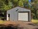 Exterior view of detached garage with roll up doors at 5130 English Dr, Cumming, GA 30041
