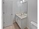 Bathroom features a tiled floor, vanity, sink, and modern fixtures at 5763 Mitchell Chase Trl, Mableton, GA 30126