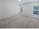 Empty bedroom with neutral walls, carpeted floor, and two windows offering natural light and views at 5763 Mitchell Chase Trl, Mableton, GA 30126