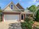 Charming two-story home with brick accents, a well-manicured lawn, and an attached two-car garage at 5763 Mitchell Chase Trl, Mableton, GA 30126