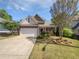 Charming two-story home with brick accents, a well-manicured lawn, and an attached two-car garage at 5763 Mitchell Chase Trl, Mableton, GA 30126