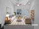 Bright living room with neutral tones, vaulted ceilings, modern furnishings, and a decorative ceiling fan at 5763 Mitchell Chase Trl, Mableton, GA 30126