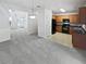 Open-concept living area with neutral carpet flows into the kitchen featuring wood cabinets and black appliances at 5763 Mitchell Chase Trl, Mableton, GA 30126