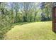 Lush green backyard with mature trees, providing a private outdoor space at 120 Westwood Nw Dr, Marietta, GA 30064