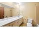 Bathroom with a wide mirror, vanity, and standard toilet at 120 Westwood Nw Dr, Marietta, GA 30064