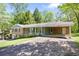 Traditional brick home featuring a carport and driveway at 120 Westwood Nw Dr, Marietta, GA 30064
