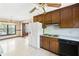 Traditional kitchen featuring wooden cabinets, a white refrigerator, and a black dishwasher at 120 Westwood Nw Dr, Marietta, GA 30064