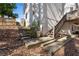 Exterior rear view of home with stairs leading to a covered deck, showcasing the home's access points and architectural details at 2125 Fairfax Dr, Alpharetta, GA 30009