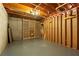 Spacious unfinished basement with exposed beams, concrete floor, and wood wine racks, awaiting your customization at 2125 Fairfax Dr, Alpharetta, GA 30009