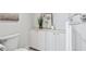 This spacious bathroom has ample storage with white cabinets and lovely marble countertops at 2125 Fairfax Dr, Alpharetta, GA 30009