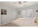 This comfortable bedroom provides carpet flooring, a ceiling fan, and a closet for storage at 2125 Fairfax Dr, Alpharetta, GA 30009