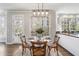 Charming breakfast nook with a glass table set, surrounded by windows offering bright natural light at 2125 Fairfax Dr, Alpharetta, GA 30009