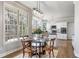Charming breakfast nook with a glass table set, surrounded by windows and opens to kitchen at 2125 Fairfax Dr, Alpharetta, GA 30009