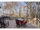 Outdoor deck features views of mature trees, a table with chairs, and rocking chairs, perfect for unwinding at 2125 Fairfax Dr, Alpharetta, GA 30009