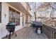 Exterior deck featuring multiple grills, overlooking the private backyard with mature trees, great for outdoor dining at 2125 Fairfax Dr, Alpharetta, GA 30009
