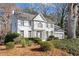 Beautiful two-story home featuring a white brick facade, landscaped front yard, and attached two-car garage at 2125 Fairfax Dr, Alpharetta, GA 30009