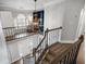 Spacious foyer with chandelier, staircase and railing, and upper level sitting area and shelving at 2125 Fairfax Dr, Alpharetta, GA 30009
