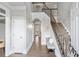 Welcoming foyer with staircase, bench seating, and hardwood floors at 2125 Fairfax Dr, Alpharetta, GA 30009
