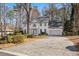 Elegant two-story home with a brick facade, landscaped front yard, and a private driveway at 2125 Fairfax Dr, Alpharetta, GA 30009