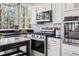 Close up of a bright kitchen featuring stainless appliances and granite countertops at 2125 Fairfax Dr, Alpharetta, GA 30009