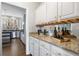 View of a kitchen with granite countertops and wine storage. Features stainless appliances and a large window at 2125 Fairfax Dr, Alpharetta, GA 30009